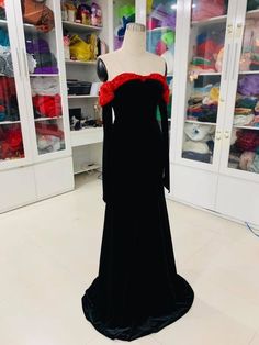 a dress on display in a room with many fabrics