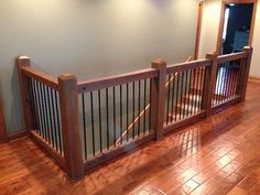 an empty room with wooden floors and railings