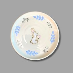 a white and blue plate with a rabbit on it