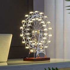 a ferris wheel is lit up on a desk