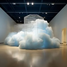 there is a large cloud in the middle of this room with a cage on it