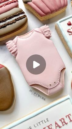 some cookies are on a table with pink icing