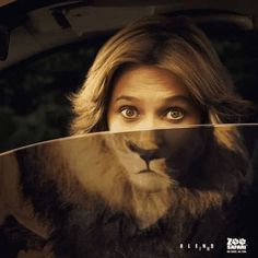 a woman is looking through the window of a car with a lion on it's face