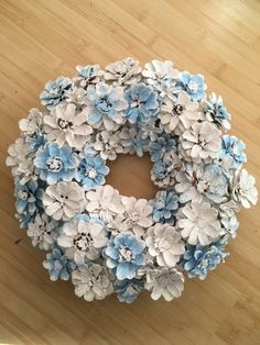 a blue and white wreath on a wooden floor