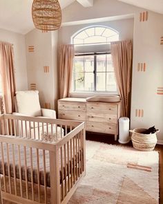 a baby's room with a crib and dresser