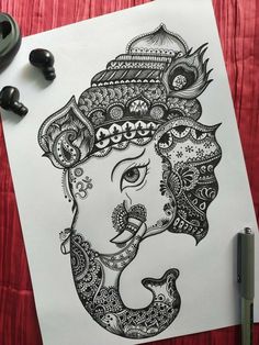 a drawing of an elephant with intricate patterns on it's face and head, next to some ink pens