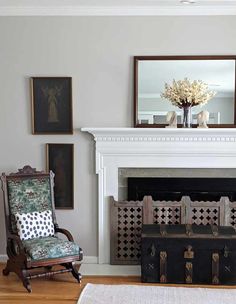 a living room filled with furniture and a fire place in front of a white fireplace