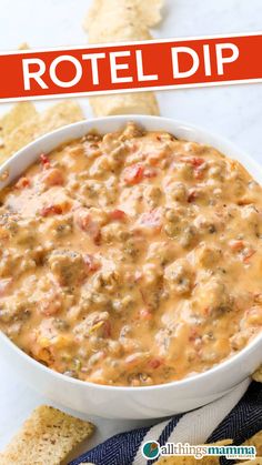 Close-up of creamy Rotel cheese dip with spicy sausage and Rotel tomatoes served in a white bowl, surrounded by tortilla chips on a marble surface.