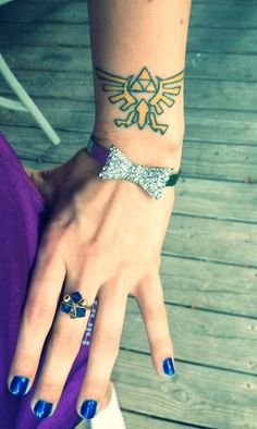 a woman's hand with tattoos and bracelets on her wrist, holding onto a purple dress