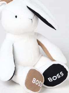 a white stuffed animal with the word boss written on it's chest and ears