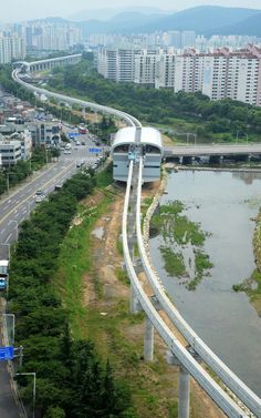 an aerial view of a highway and bridge in the middle of a city with tall buildings