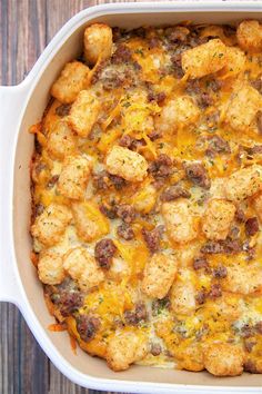 a casserole dish with tater tots and meat in it on a wooden table