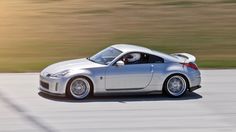 a silver sports car driving down the road