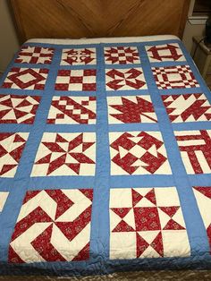 a red and white quilt on a bed