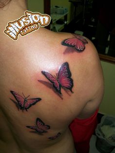 a woman's back with three butterflies on her left shoulder and the word tattoo written below it