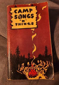 an old book with the title camp songs and things written on it's cover