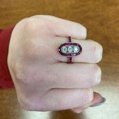 This stunning Ruby ring is set in 14k yellow gold and features three old mine cut diamonds with a total approximate weight of 0.51 carats. The diamonds are J color, and VS2-SI1 clarity. Surrounding the center stones is a row of natural calibre French-cut rubies. This ring is antique, made in Russia, with old Russian gold marks and maker marks. ✦ DIAMOND SPECIFICATIONS: Diamond Cut: Old Mine Cut ✦ ENGAGEMENT RING SPECIFICATIONS: Ring Material: Gold, Platinum Ring Era: Edwardian Era Stones: Diamon Antique Three-stone Diamond White Rings, Antique Three Stone Round Diamond Ring, Antique Three Stone Diamond White Rings, Antique Three Stone Diamond Ring In Diamond White, Antique Platinum Three Stone Diamond Ring, Antique Oval Three Stone Diamond Ring, Antique Three-stone Diamond Rings, Antique Three Stone Round Cut Rings, Antique Three Stone Platinum Rings