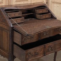 an old wooden desk with many drawers