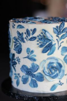 a blue and white decorated cake sitting on top of a table