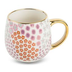 a coffee cup with flowers painted on the side and gold trimming around the rim