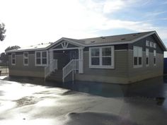 a mobile home sits in the middle of a parking lot with no one around it