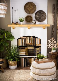 a living room filled with lots of furniture and bookshelves next to a fire place