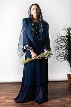 Navy blue kurta with hand embroidered glass beads and sequin work. Paired with crepe palazzo and silk organza dupatta.
Component: 3
Pattern: Embroidered
Type Of Work: Glass beads,thread work,sequin work
Neckline: Round
Sleeve Type: Bell sleeves
Fabric: Georgette,crepe, soft net
Color: Blue
Other Details: 
Floral embroidered front placket
Sheer dupatta
Scallop border
Sheer sleeves
Occasion: Mehendi and Haldi - Aza Fashions Sheer Dupatta, Kurta Palazzo Set, Scallop Border, Blue Kurta, Palazzo Set, Straight Kurta, Organza Dupatta, Net Dupatta, Indian Fashion Designers