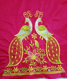 two birds are sitting on top of a pink cloth with flowers and leaves in the center