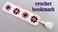 a crochet bookmark with poinsettis and tassel on it