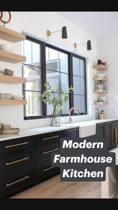 a kitchen with black cabinets and white counter tops is pictured in this image, there are shelves on the wall above the sink