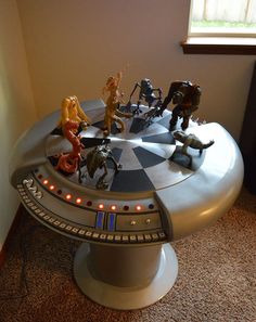 star wars action figures sit on top of a table