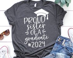 a t - shirt that says proud sister of a graduate in white on the front