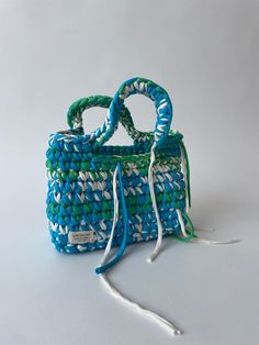 a small blue and white basket with handles on the side, sitting on a table