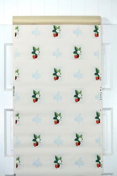 an apple print roman blind hanging on the wall