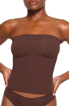 Sculpt your body's natural shape with a tube top from Kim Kardashian's SKIMS that holds you in and lifts you up in all the right places. Reflecting the brand's passion for highly technical shapewear solutions for every body, this tube top has whisper-soft seamless construction and is ideal as an underpinning or a solo piece. 15 1/2" length (size medium) 76% nylon, 24% spandex Machine wash, tumble dry Imported lined