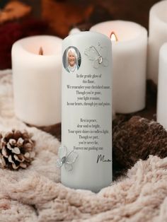 a memorial bookmark with a poem on it next to some candles and pine cones