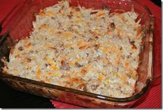 a casserole dish filled with cheese and other toppings on a red table cloth