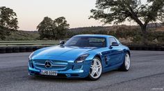 a blue mercedes sports car parked in a parking lot