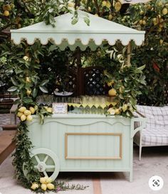 an outdoor bar with lemons and greenery on the outside, next to a bed