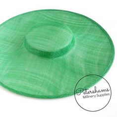 This emerald cartwheel hat base is a classic shape that has sprung into popularity in the past year. Made from 2 layers of stiffened sinamay, these cartwheels are ready to trim and are fitted with a petersham ribbon on the inside crown edge. Simply add a comb or headband to secure to the head.Hat base measures:Width: 35.5cm (14 inches)Crown Width: 13.5cm (5.3 inches)Crown Height: Approximately 3.5cm (1.7 inches)For even more millinery supplies you can find us here:www.etsy.com/shop/PetershamsAll Green Flat Cap For Summer, Green Summer Flat Cap, Green Flat Brim Hat For Kentucky Derby, Adjustable Green Brimmed Boater Hat, Adjustable Brimmed Green Mini Hats, Adjustable Green Brimmed Mini Hats, Green Brimmed Sun Hat For Kentucky Derby, Green Short Brim Sun Hat For Kentucky Derby, Adjustable Green Top Hat For Spring