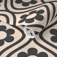 an abstract black and white wallpaper with flowers on the side, featuring a circular design