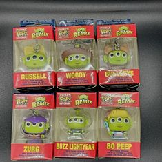 six buzz lightyear keychains are on display in their packagings for sale