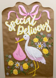 a brown paper bag with a stork holding a pink purse and the words special delivery painted on it