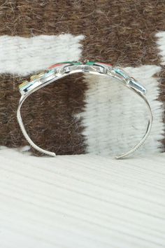 This turquoise, coral, mother of pearl, jet and sterling silver inlay butterfly bracelet was made by Zuni silversmith Tamara Pinto. The inside is stamped sterling.Size: 5 1/8" (will fit up to a 6 1/4" wrist)Gap: 1 1/8"Length: 1 1/4"Free shipping on all orders! We ship with USPS and always include tracking. All orders ship within a day of payment.Returns are accepted up to 30 days after you receive your order. Just send us a message. Our shop offers cash back or store credit. The item must be ret Adjustable Multicolor Inlay Bracelets, Southwestern Sterling Silver Inlay Bracelet Gift, Multicolor Sterling Silver Bracelet With Inlay, Multicolor Sterling Silver Bracelets With Inlay, Multicolor Inlay Sterling Silver Bracelets, Multicolor Artisan Bracelet With Inlay, Artisan Multicolor Bracelets With Inlay, Adjustable Multicolor Inlay Jewelry, Multicolor Artisan Inlay Bracelets