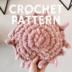 a person holding up a pink object with the words crochet pattern on it