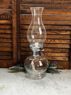 a clear glass vase sitting on top of a table