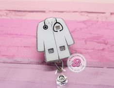 "Lab coat badge reel: If you are looking for a unique gift then look no further! This retractable badge reel is perfect for any occasion.  Lab coat is 2\" Cord length 34\" You may choose a swivel clip, belt clip, lanyard, or carabiner. Please do not allow children to play with the badge reels. Made in a smoke free and pet free studio. Don't hesitate to send me a message if you have questions. I will usually respond back within an hour from 8am-10pm-EST." Cute White Badge Reel For Gift, Playful White Badge Reel For Gifts, Dermatology Badge Reel, Personalized Fun White Badge Reel, Science Badge Reel, Novelty Personalized White Badge Reel, Star Labs, Lab Tech, Nurse Badge Reel