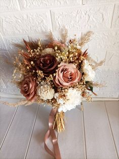 a bridal bouquet with roses and other flowers