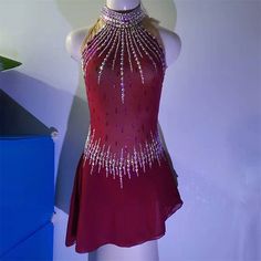 a mannequin wearing a red dress with silver sequins on it's neck