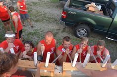 a group of people in red shirts holding baseball bats